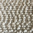 chunky wool slab rug in the color vanilla or white