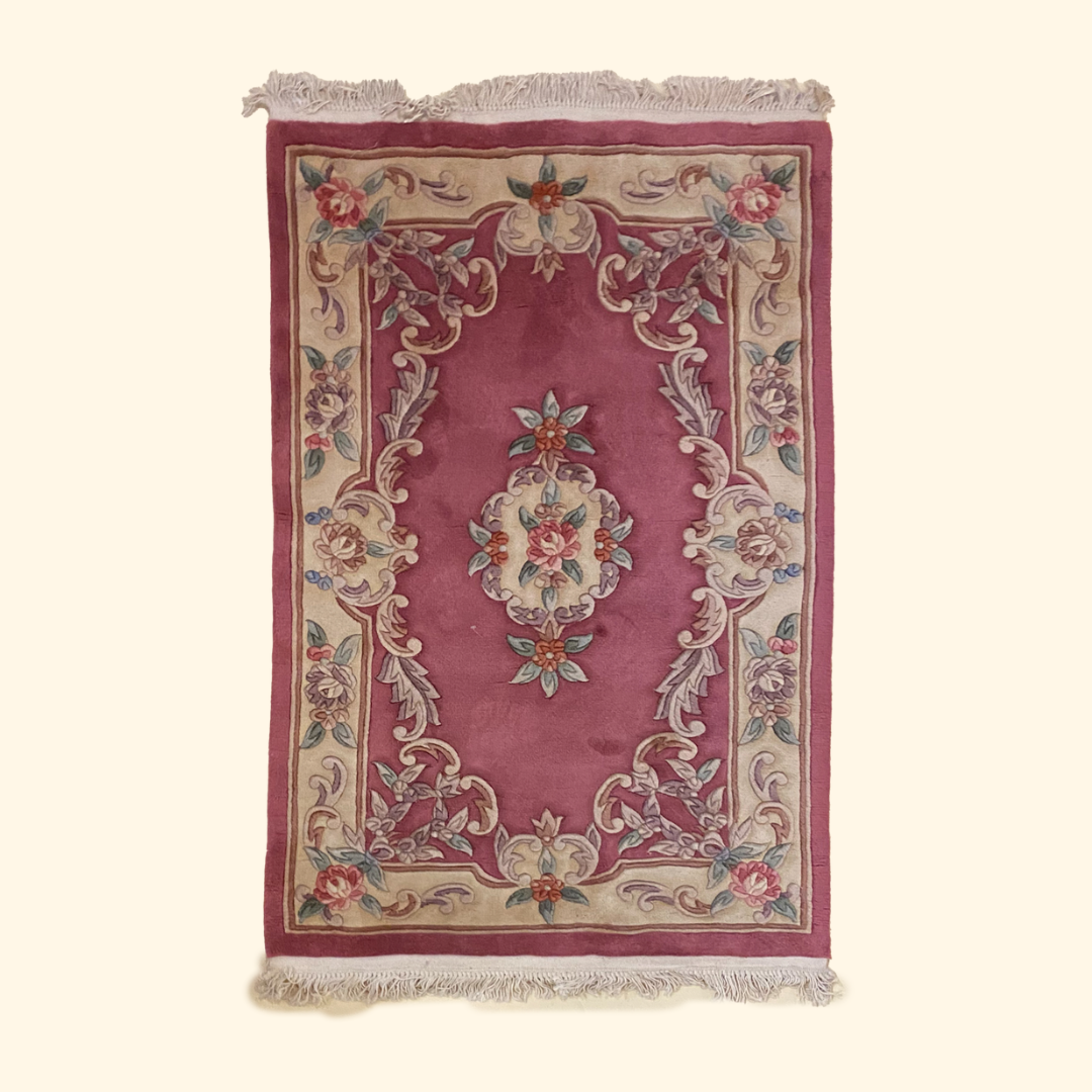 rose colored puffy and thick tassled vintage rug