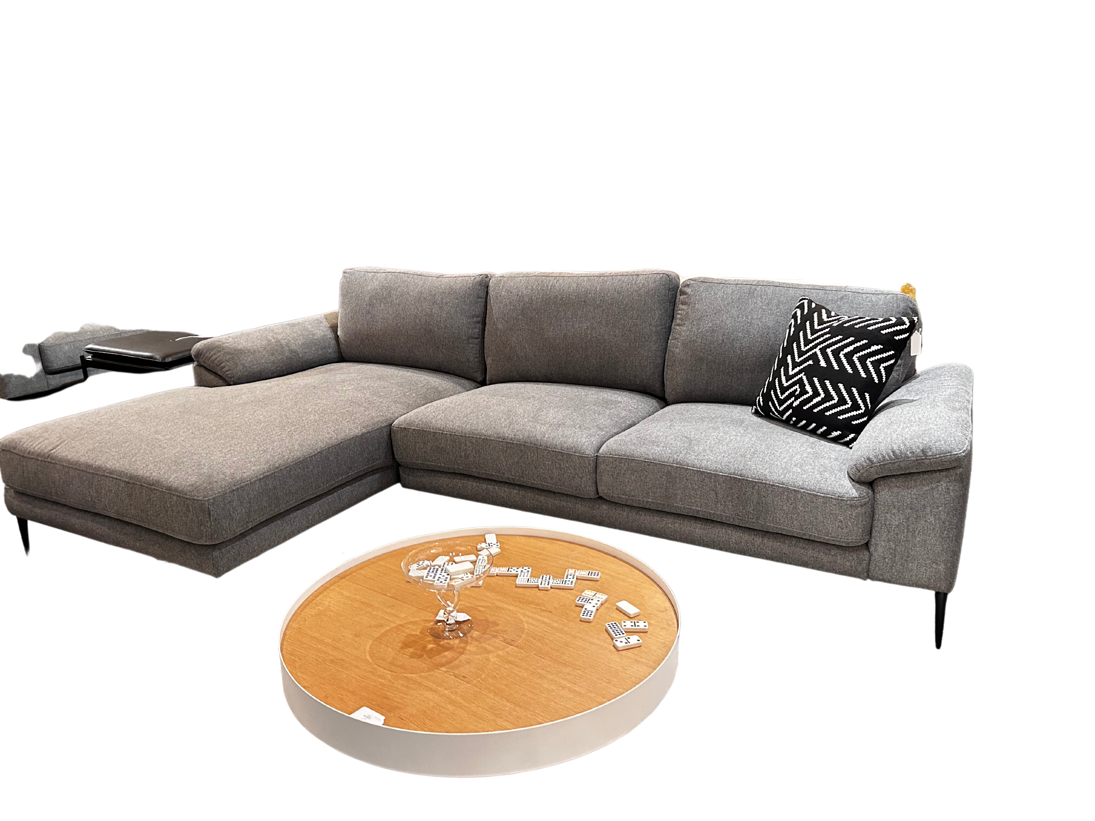 sectional sofa in a light grey with modern black legs, firm and well built. 